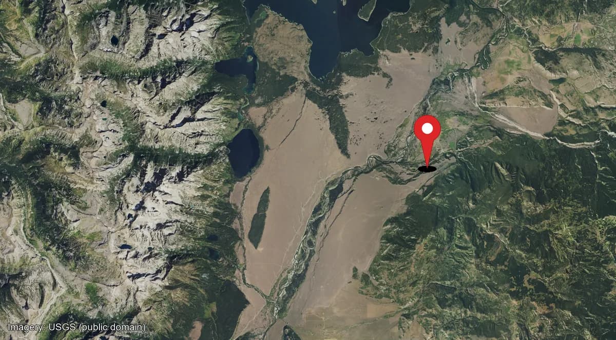 Satellite view with a single map pin marking where the camera is